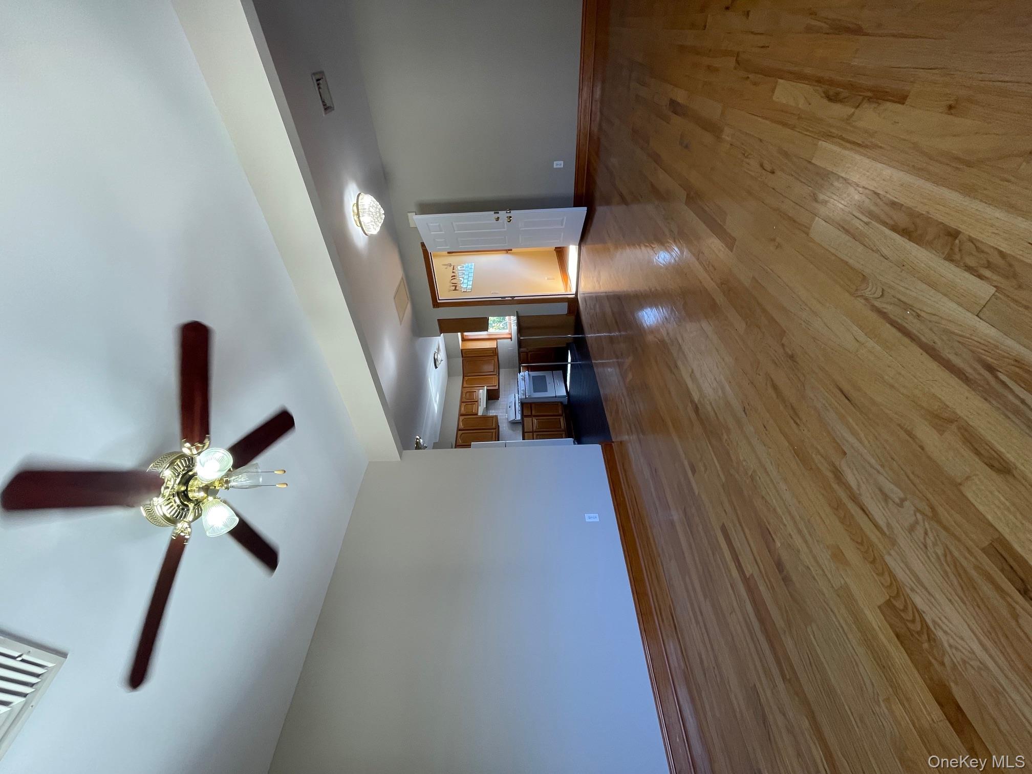 57 Ashland Street, Unit 2 New Rochelle, NY 10801 - Photo 3 of 19 Unfurnished living room with dark wood-type flooring and a ceiling fan