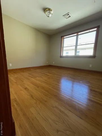 a view of an empty room and wooden floor