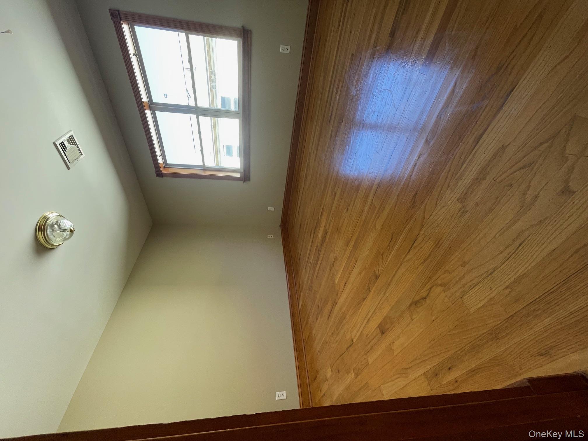 57 Ashland Street, Unit 2 New Rochelle, NY 10801 - Photo 6 of 19 Spare room with baseboards and light wood-type flooring
