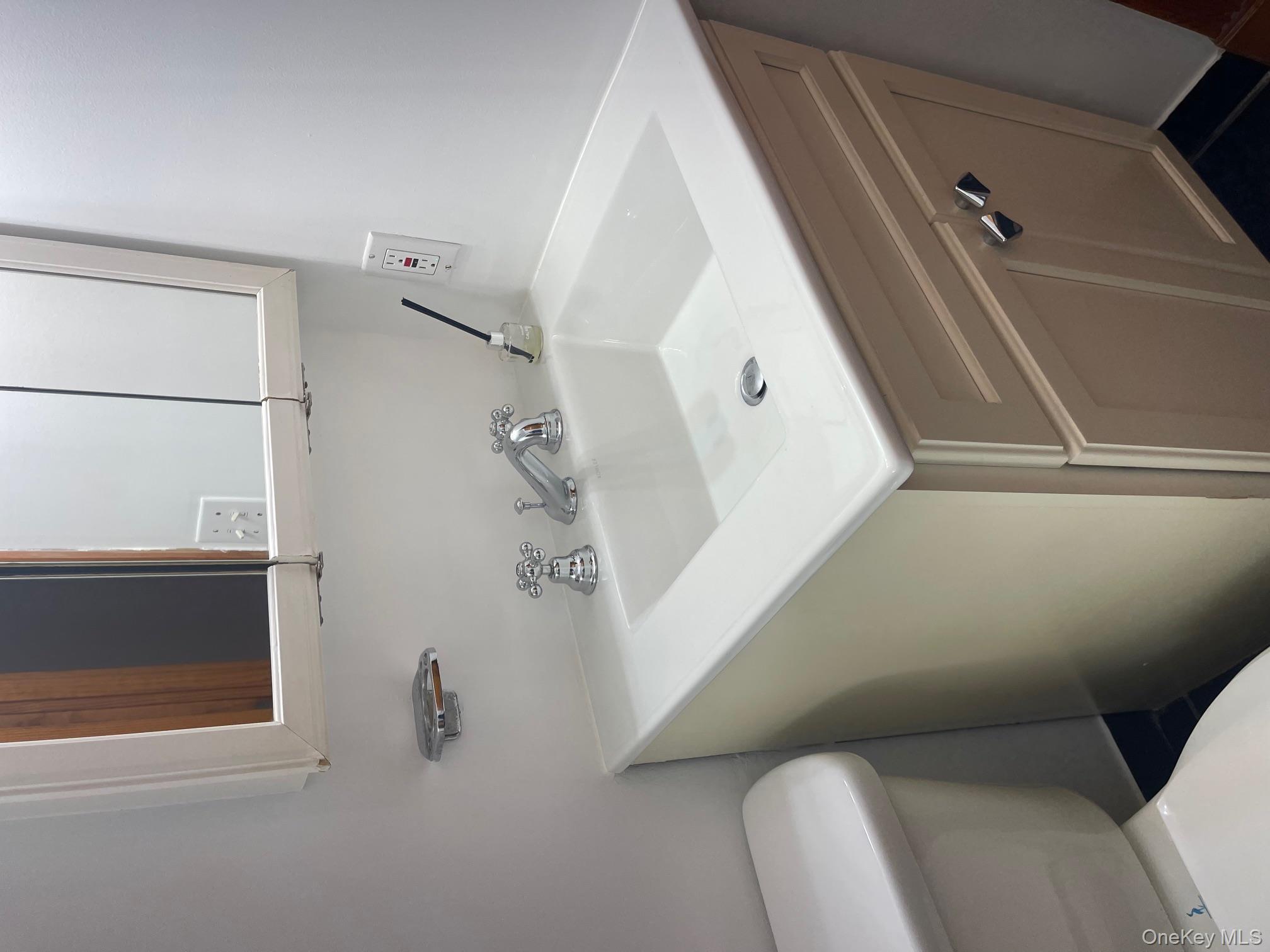 57 Ashland Street, Unit 2 New Rochelle, NY 10801 - Photo 10 of 19 Half bath with vanity and toilet