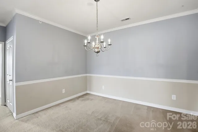 an empty room with a window and ceiling fan