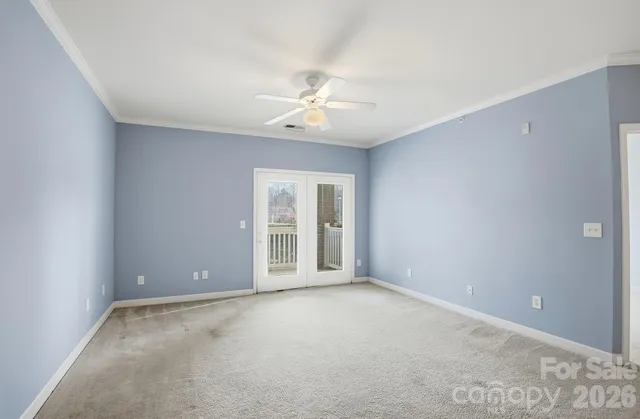 a view of a livingroom with a ceiling fan and kitchen space with a sink