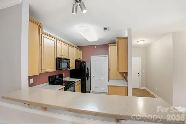 a kitchen with a sink stove and microwave