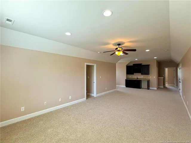 a kitchen with a granite countertop sink and cabinets