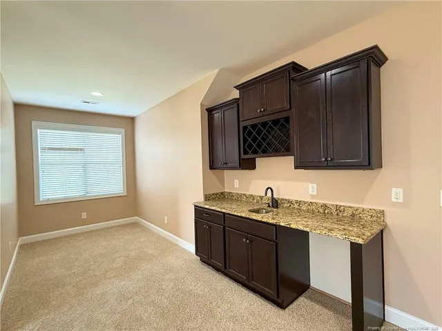 a kitchen with granite countertop a stove and a refrigerator