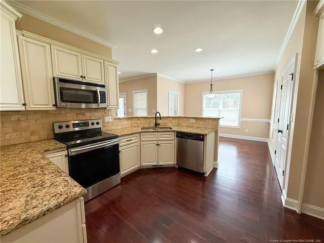 a kitchen with sink cabinets and microwave
