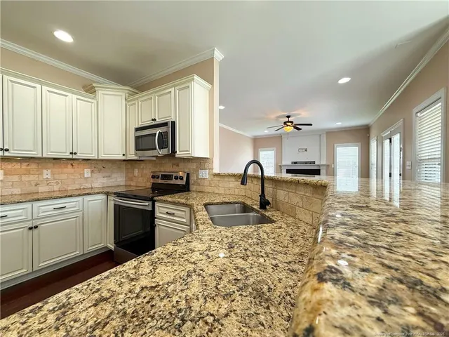 a view of kitchen with furniture and wooden floor