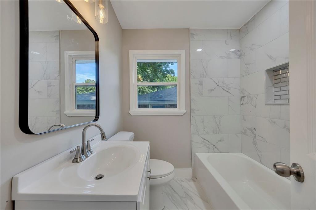 202 Oakcliff Court Northwest Atlanta, GA 30331 - Photo 12 of 27 a bathroom with a sink a toilet and shower