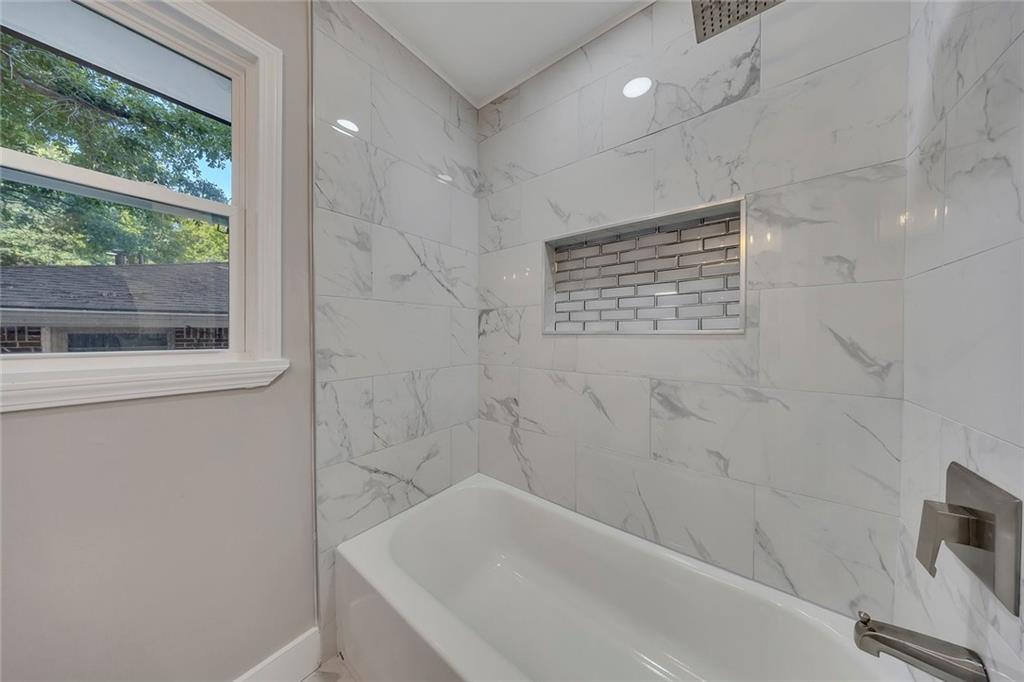 202 Oakcliff Court Northwest Atlanta, GA 30331 - Photo 13 of 27 a bathroom with a bathtub and a shower
