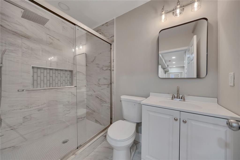 202 Oakcliff Court Northwest Atlanta, GA 30331 - Photo 16 of 27 a bathroom with a toilet sink and shower