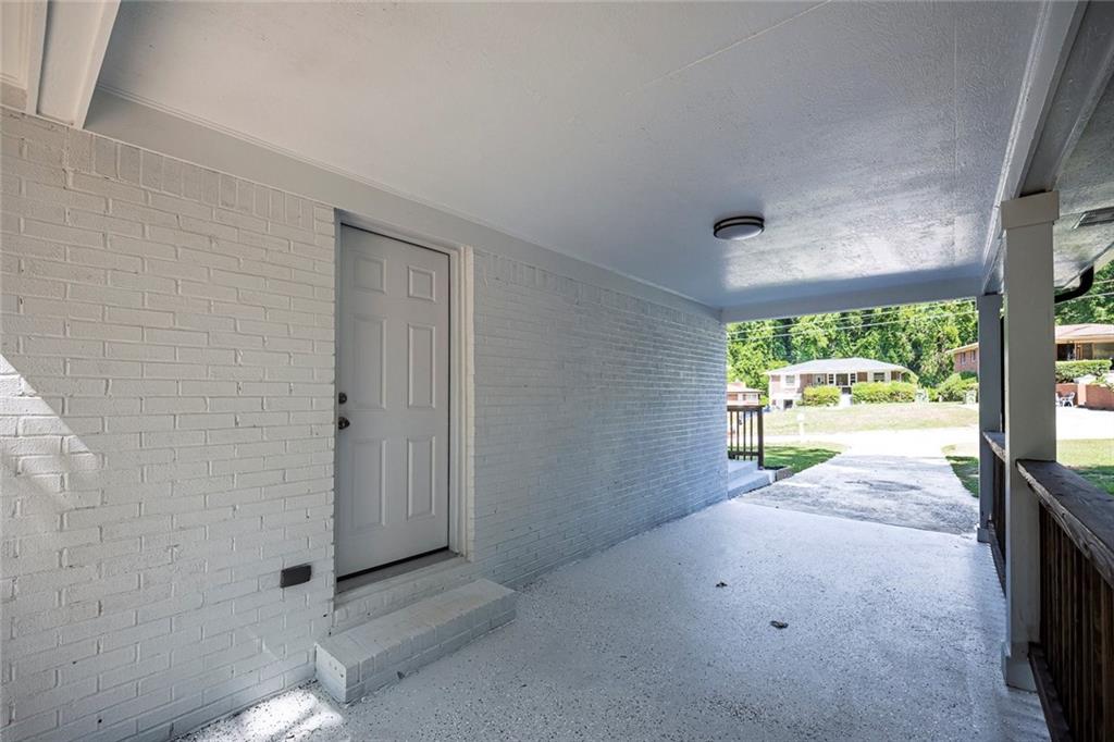 202 Oakcliff Court Northwest Atlanta, GA 30331 - Photo 24 of 27 a view of an empty room with a floor to ceiling window and a flat screen tv