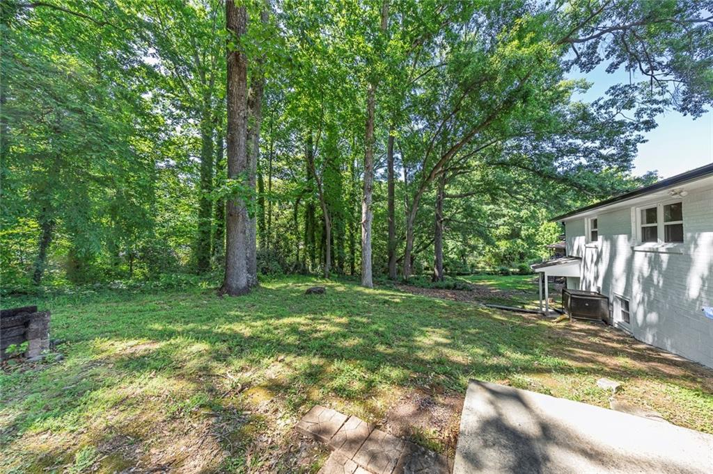 202 Oakcliff Court Northwest Atlanta, GA 30331 - Photo 25 of 27 a view of a backyard with wooden fence and large trees
