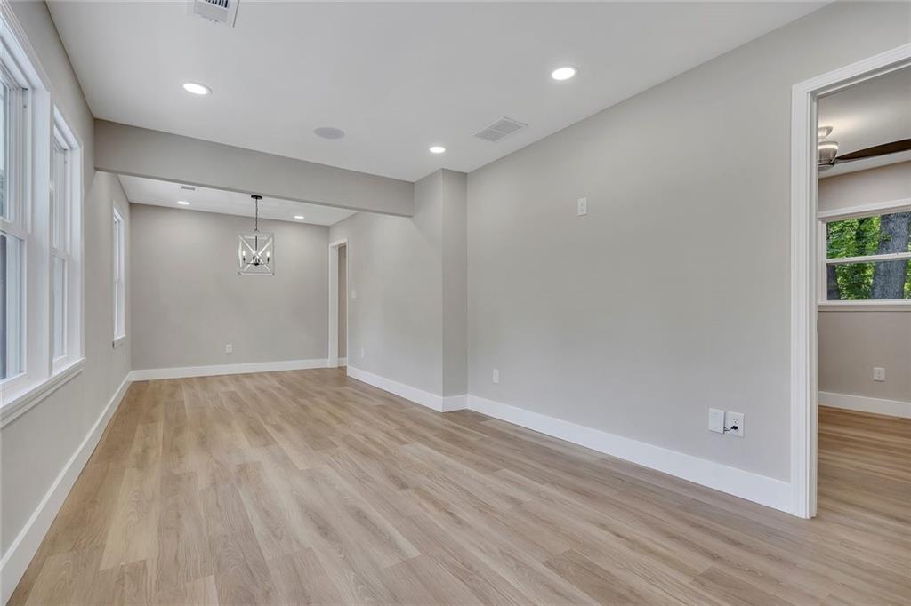 202 Oakcliff Court Northwest Atlanta, GA 30331 - Photo 4 of 27 an empty room with wooden floor and windows