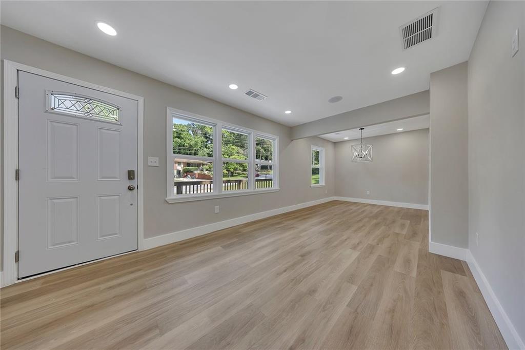 202 Oakcliff Court Northwest Atlanta, GA 30331 - Photo 5 of 27 an empty room with wooden floor and windows