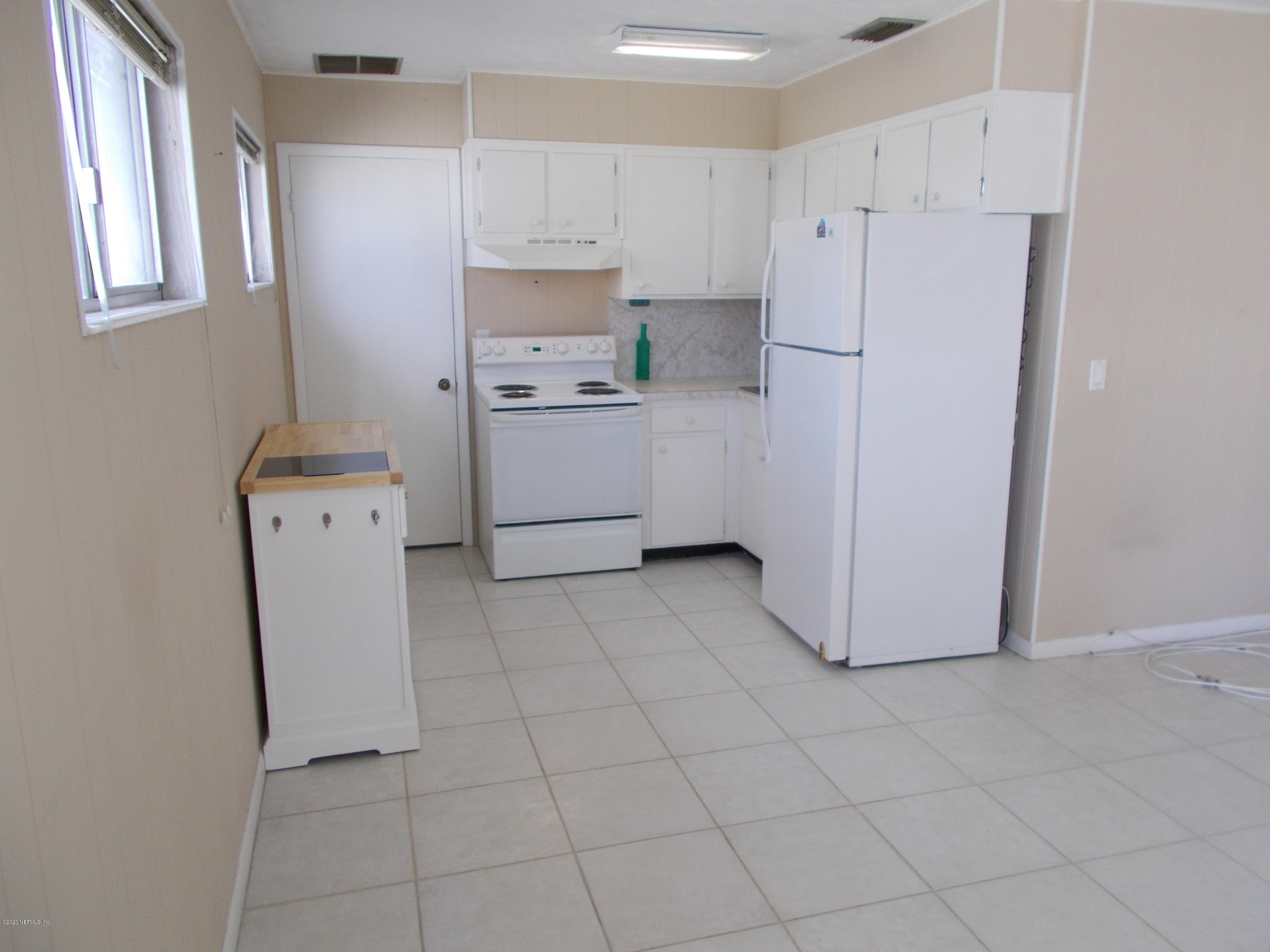 1500 First Street, Unit B Neptune Beach, FL 32266 - Photo 3 of 13 a kitchen with cabinets a refrigerator and a stove