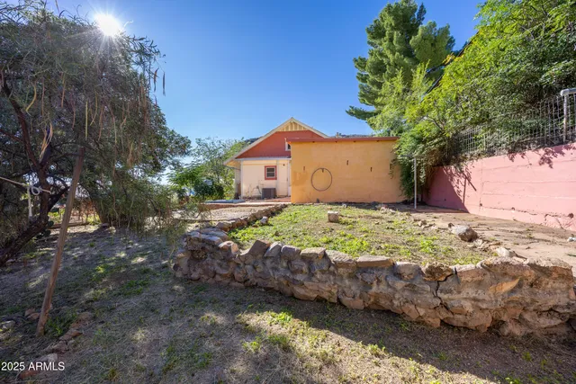 a backyard of a house with a yard and outdoor seating