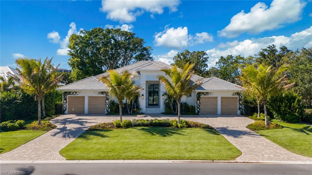 4851 Crayton Road Naples, FL 34103 - Photo 1 of 33 a front view of a house with garden