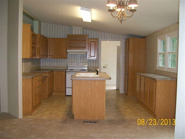 168 Wilson Cemetery Road Northeast Check, VA 24072 - Photo 2 of 14 a kitchen with a sink refrigerator and cabinets
