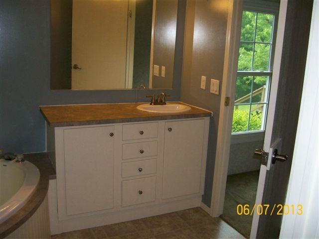 168 Wilson Cemetery Road Northeast Check, VA 24072 - Photo 8 of 14 a bathroom with a granite countertop sink and a mirror