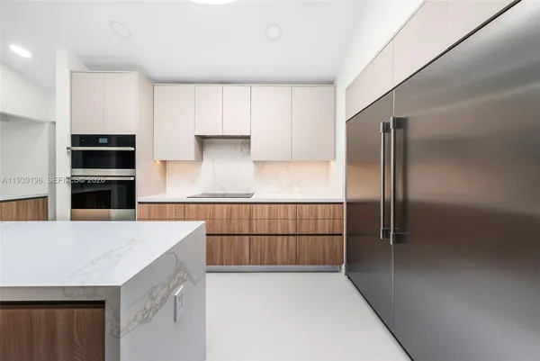 a kitchen with stainless steel appliances a refrigerator and a stove top oven
