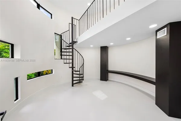 a view of a room with wooden floor and a large window