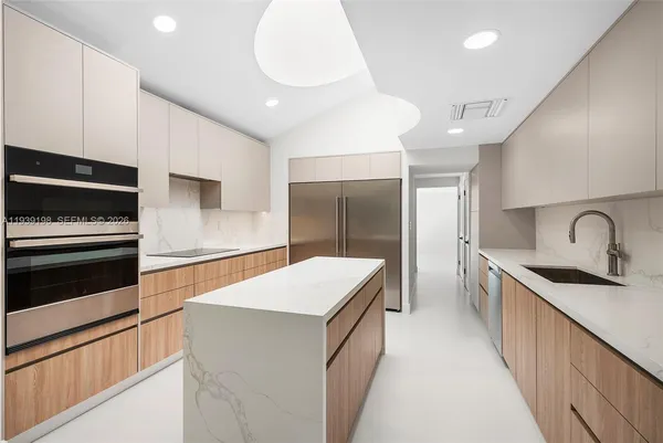 a open kitchen with cabinets and stainless steel appliances