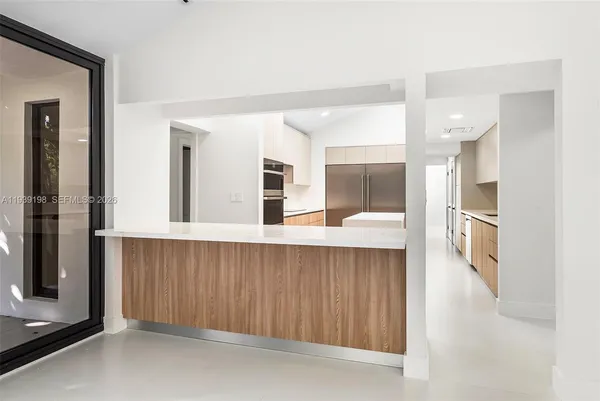 a kitchen with a sink and stainless steel appliances
