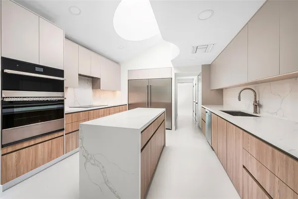 a kitchen with stainless steel appliances a refrigerator and a stove