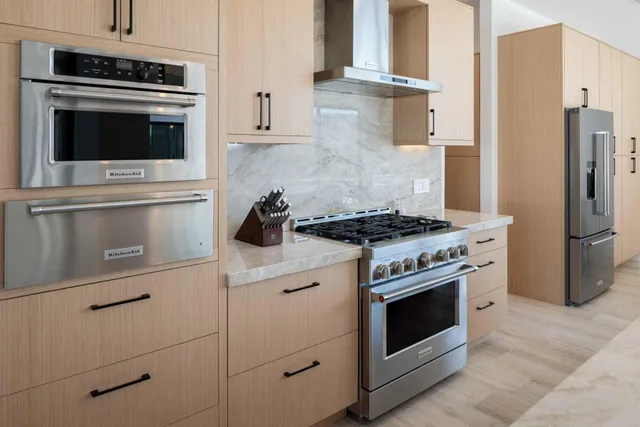 a kitchen with cabinets stainless steel appliances and a counter space