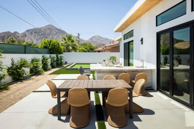 a balcony with table and chairs