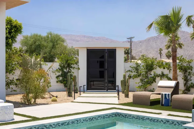 a view of a house with backyard and sitting area