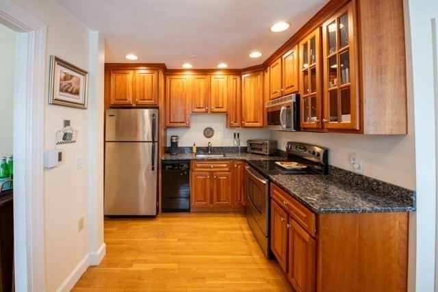 5 Porter Road, Unit 102 Andover, MA 01810 - Photo 12 of 26 a kitchen with a refrigerator a stove top oven a sink and dishwasher