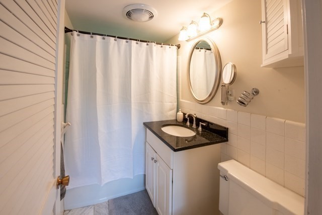5 Porter Road, Unit 102 Andover, MA 01810 - Photo 16 of 26 a bathroom with a granite countertop sink and a mirror