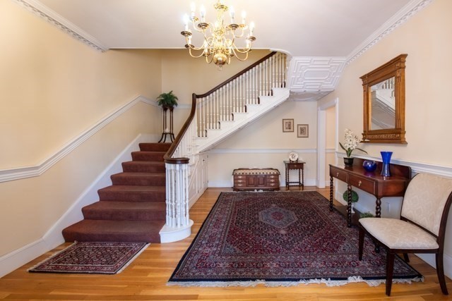 5 Porter Road, Unit 102 Andover, MA 01810 - Photo 6 of 26 a living room with furniture and a chandelier