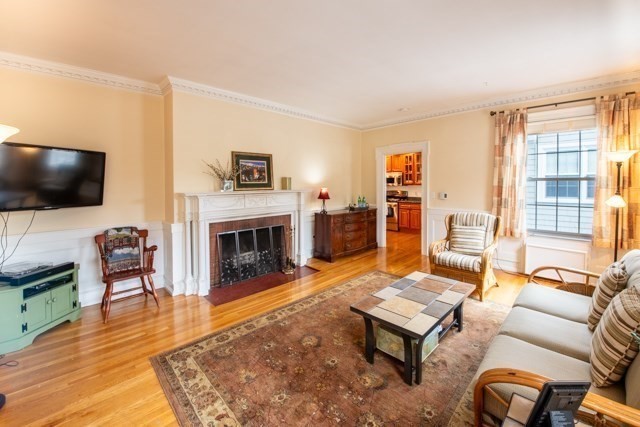 5 Porter Road, Unit 102 Andover, MA 01810 - Photo 10 of 26 a living room with furniture a flat screen tv and a fireplace