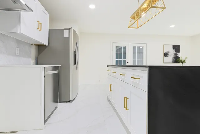 a view of a room with a ceiling fan and window