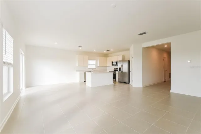 a view of a kitchen with a sink and a refrigerator