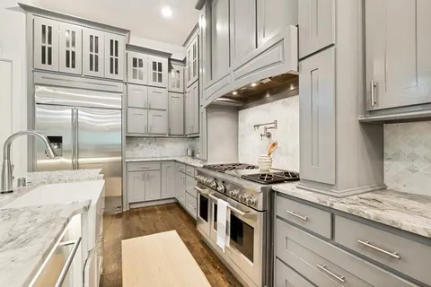 a kitchen with stainless steel appliances granite countertop a stove and a sink