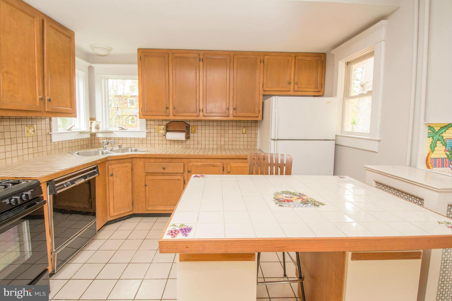 10 Mallow Hill Road Baltimore, MD 21229 - Photo 11 of 30 a kitchen with a sink a stove top oven a sink a counter top space and cabinets
