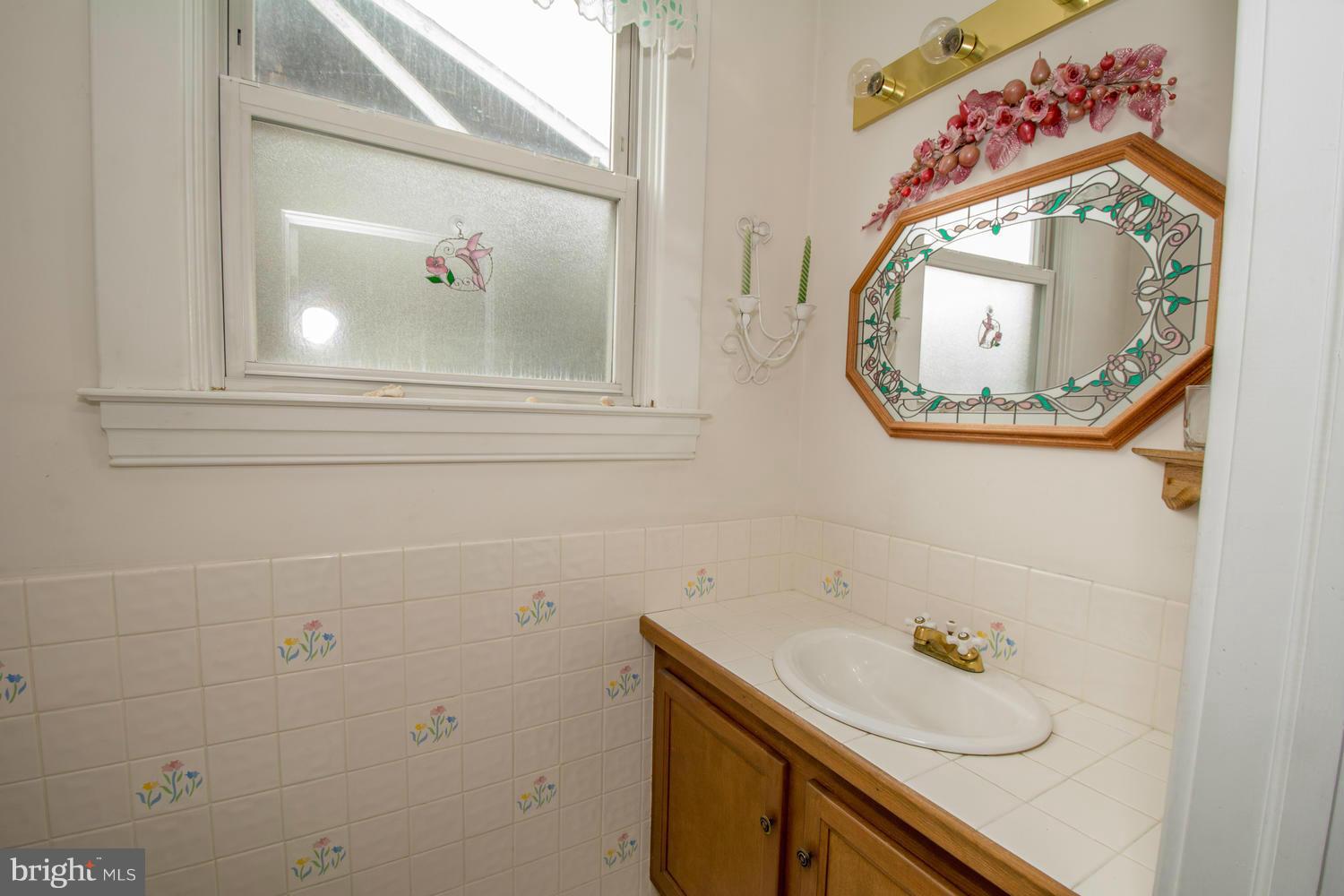10 Mallow Hill Road Baltimore, MD 21229 - Photo 15 of 30 a bathroom with a sink and mirror