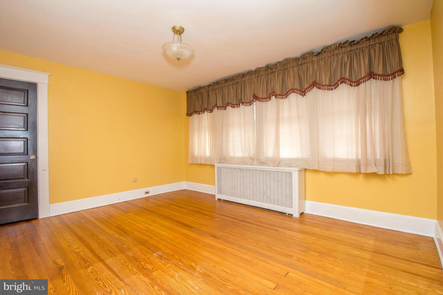 10 Mallow Hill Road Baltimore, MD 21229 - Photo 18 of 30 a view of a bedroom with wooden floor and a window