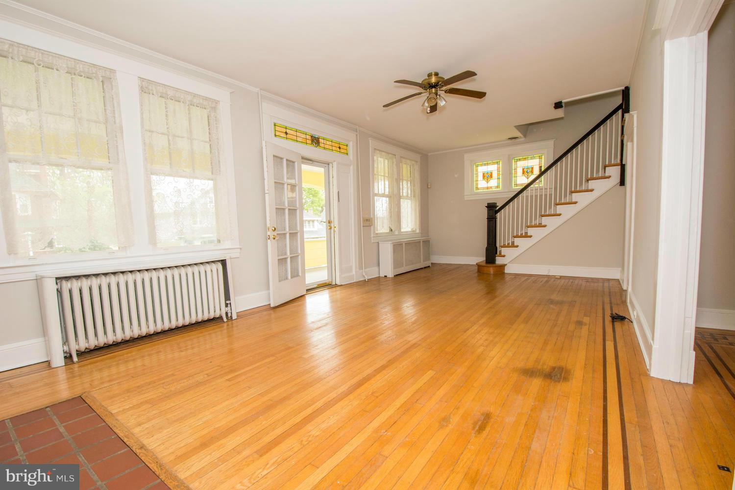 10 Mallow Hill Road Baltimore, MD 21229 - Photo 3 of 30 a view of an empty room with wooden floor and a window