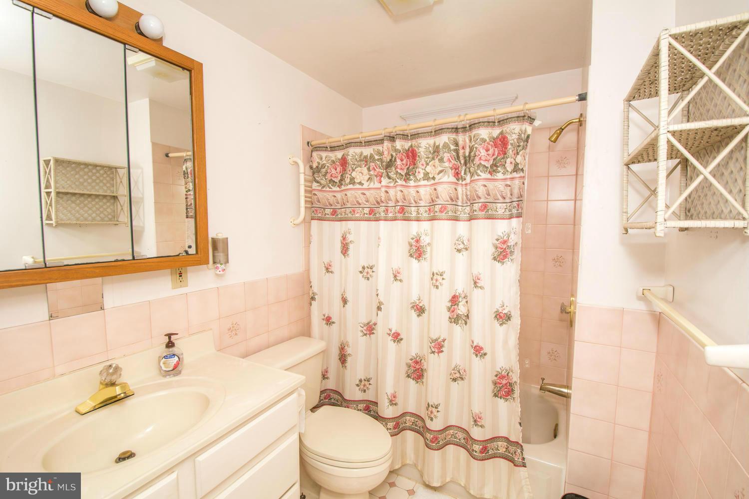 10 Mallow Hill Road Baltimore, MD 21229 - Photo 22 of 30 a bathroom with a sink toilet vanity and shower