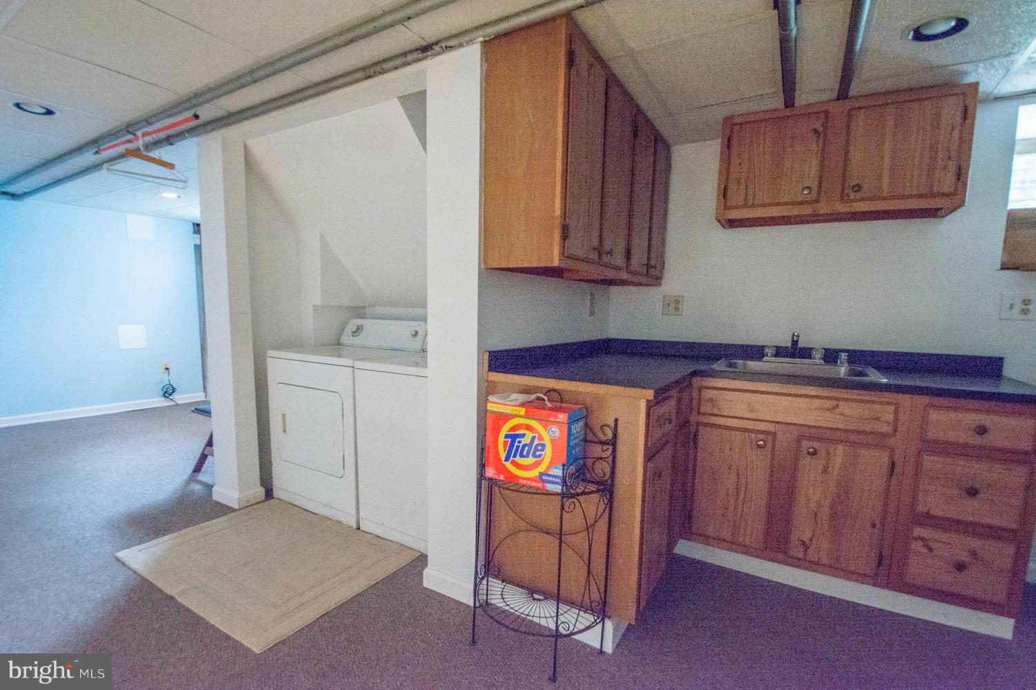 10 Mallow Hill Road Baltimore, MD 21229 - Photo 26 of 30 a utility room with granite countertop a sink and dishwasher a stove with wooden floor