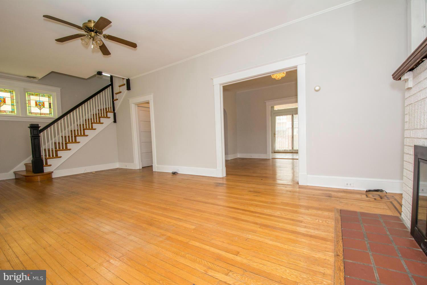 10 Mallow Hill Road Baltimore, MD 21229 - Photo 4 of 30 a view of empty room with wooden floor and fan