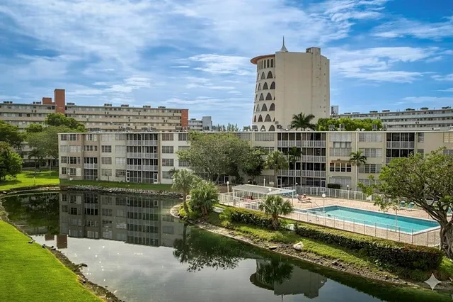 a view of a swimming pool with a view of tall buildings