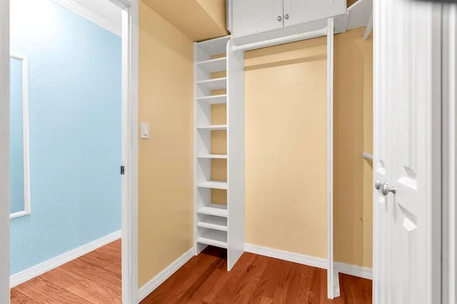 a view of a room with wooden floor and closet