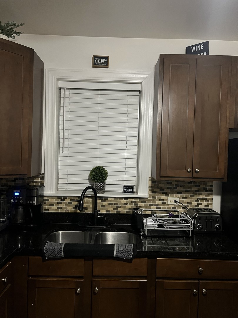 4920 West Monroe Street Chicago, IL 60644 - Photo 3 of 7 a kitchen with a sink and cabinets