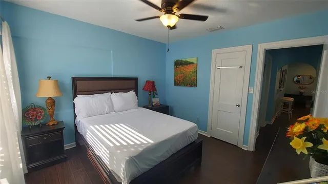 a bedroom with a bed and a chandelier