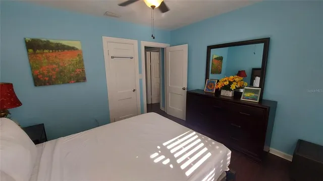 a bedroom with a bed and a painting on the wall